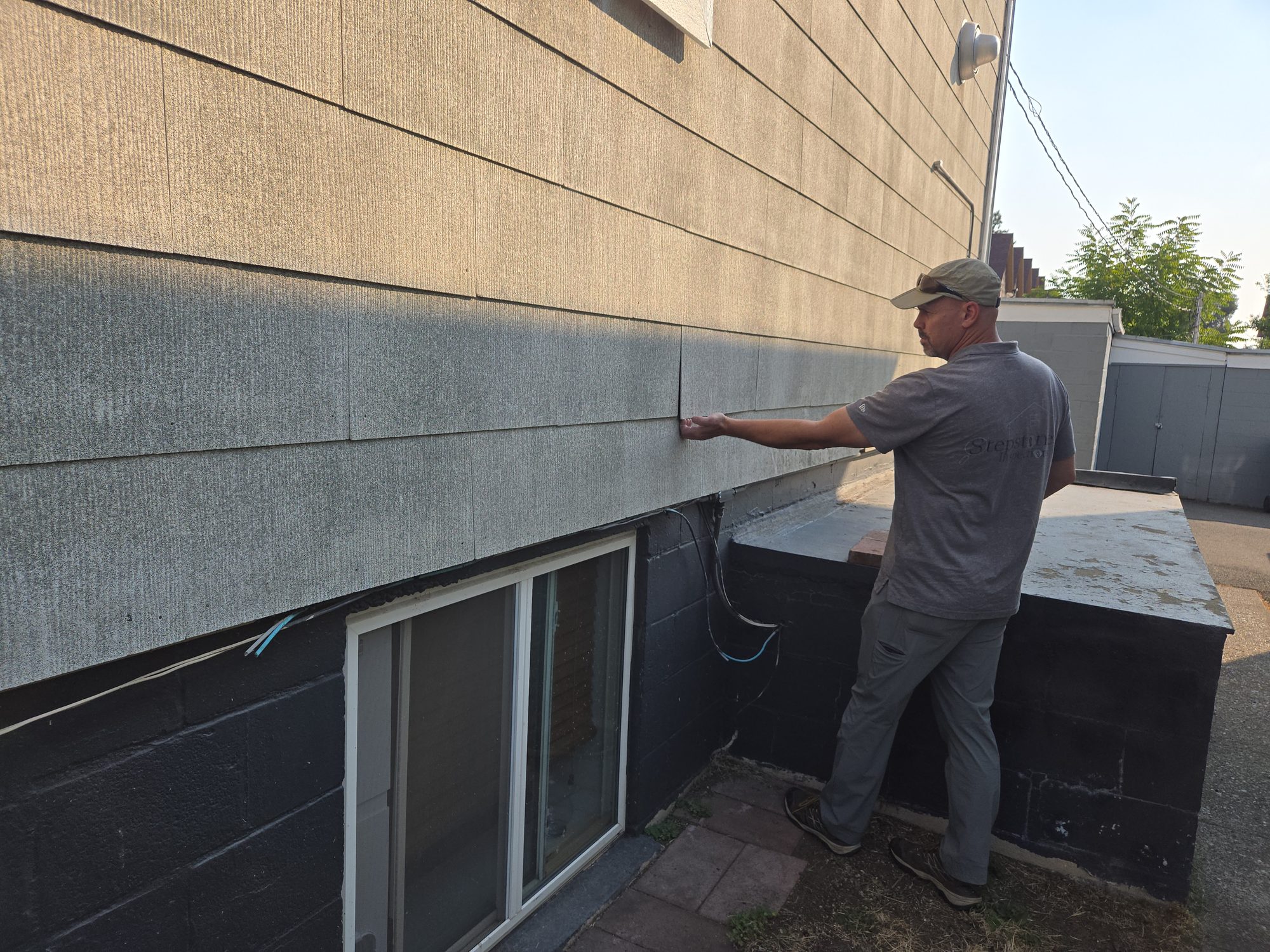 Inspector examining asbestos-containing siding