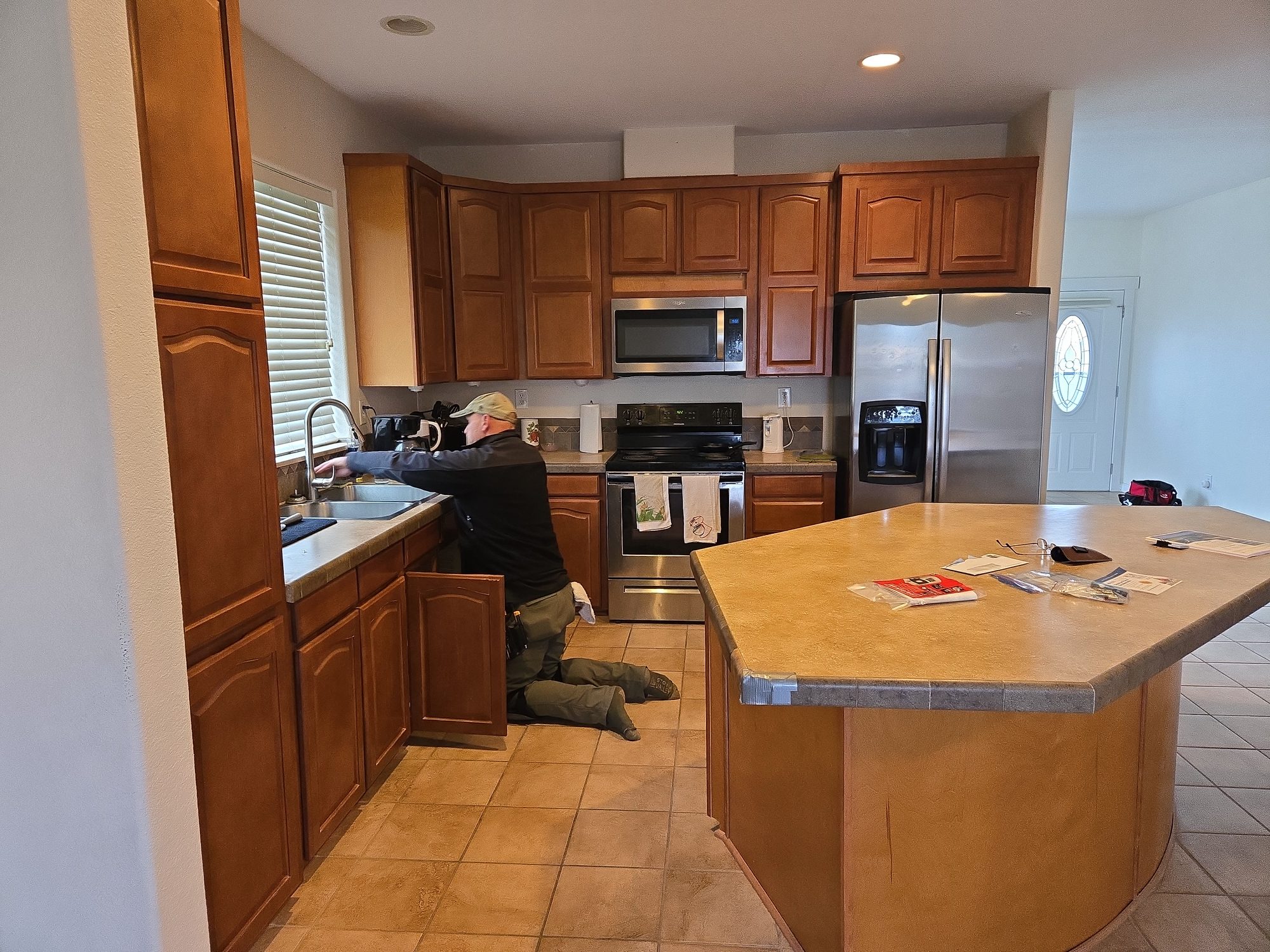 Inspector checking a kitchen sink and plumbing fixtures